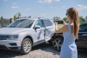 woman taking photo evidence of crash scene