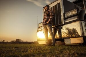 trucker standing in front of truck