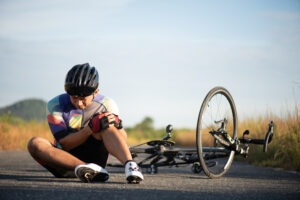 male cyclist on ground after crash